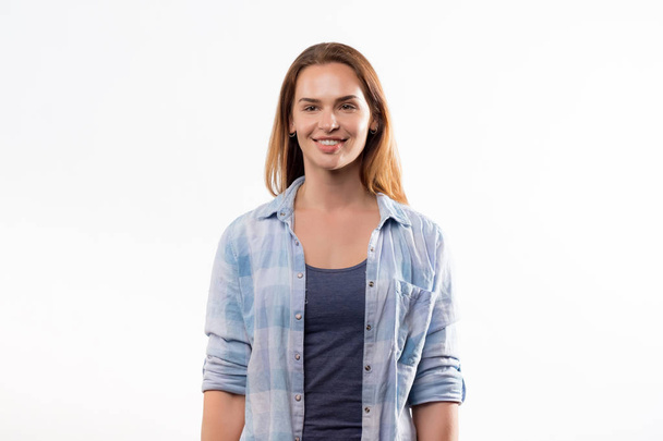 portrait of beautiful and happy woman in blue denim shirt isolated on white background  - 写真・画像