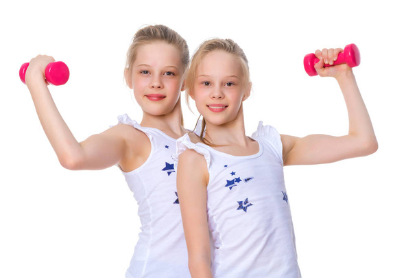 Girls gymnasts show their muscles. - Foto, afbeelding