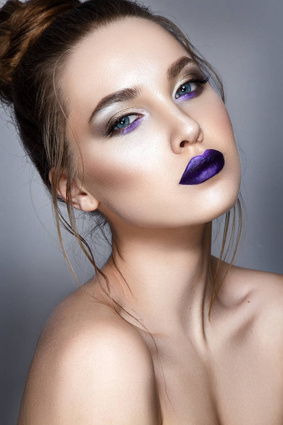 Portrait of young model with violet glossy lipstick on white background - Foto, Imagem