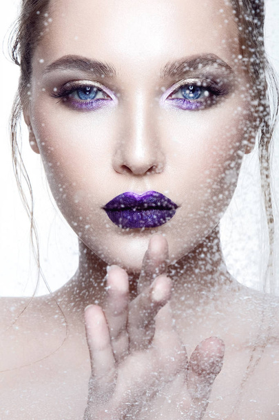 Portrait of young model with violet glossy lipstick on white background - Foto, Imagen