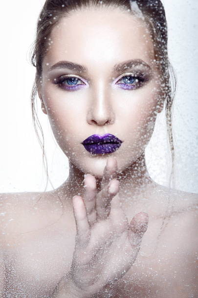 Portrait of young model with violet glossy lipstick on white background - Foto, immagini