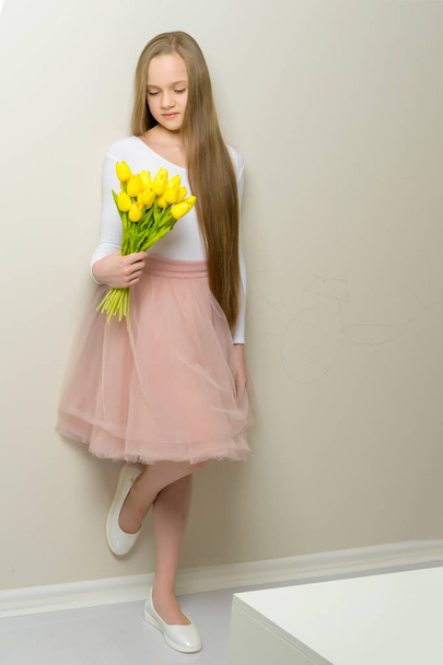 Little girl with a bouquet of tulips. - Fotografie, Obrázek