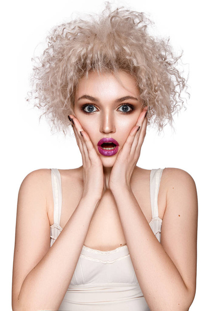 Surprised curly model with pink lips posing on white background - Φωτογραφία, εικόνα
