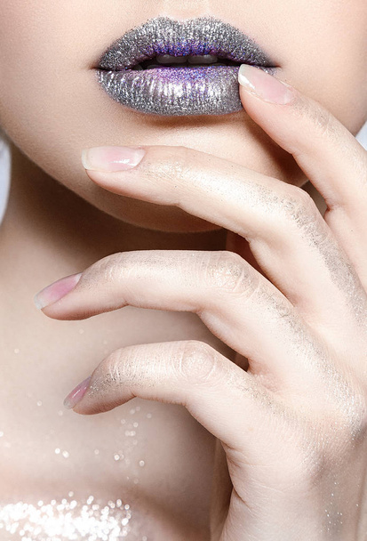Close view of glossy female lips and hand with natural polish  - Foto, imagen
