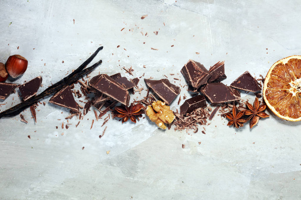 dark chocolate bars  with anise and nutson stone table and broke - Photo, Image