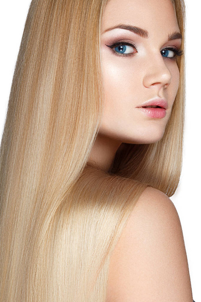 Portrait of blonde model with smooth long hair on white background - Valokuva, kuva