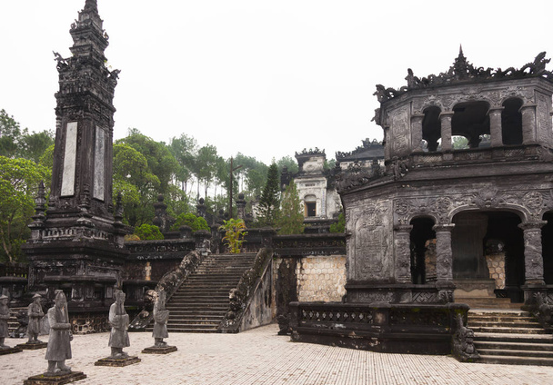Hue, Vietnam. Royal Khai Dinh Tomb complex from salutation court with Emperor's honor guard, Stele House, one of two Obelisks and stairs leading to the Thien Dinh Palace where Khai Dinh Emperor is buried. - Foto, Imagen