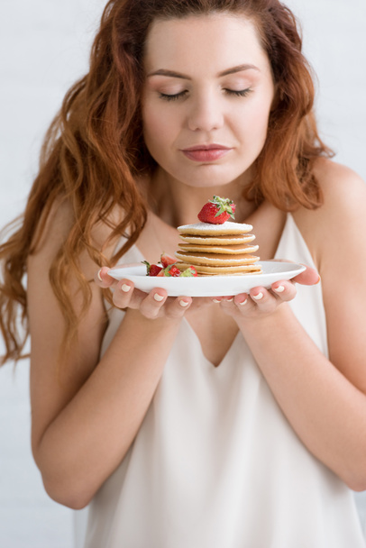 sensual young woman with delicious pancakes on plate - Fotografie, Obrázek