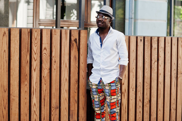 Stylish african american man in white shirt and colored pants wi - Valokuva, kuva