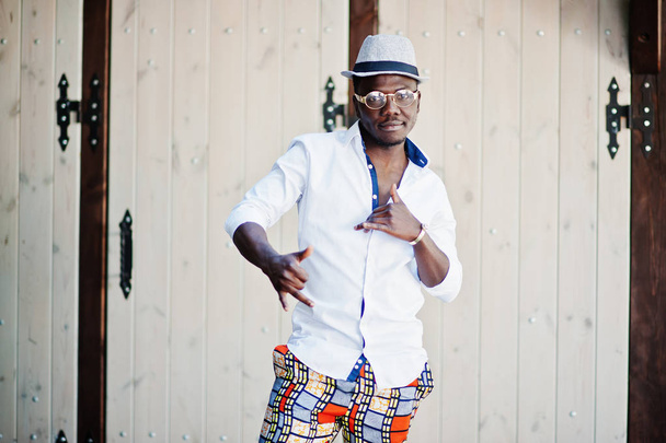 Stylish african american man in white shirt and colored pants wi - Photo, image