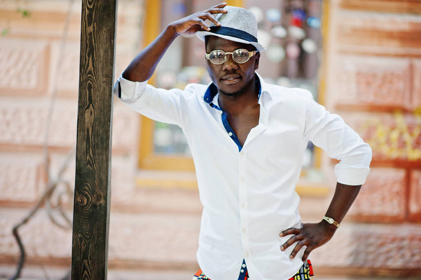 Stylish african american man in white shirt and colored pants wi - Fotó, kép