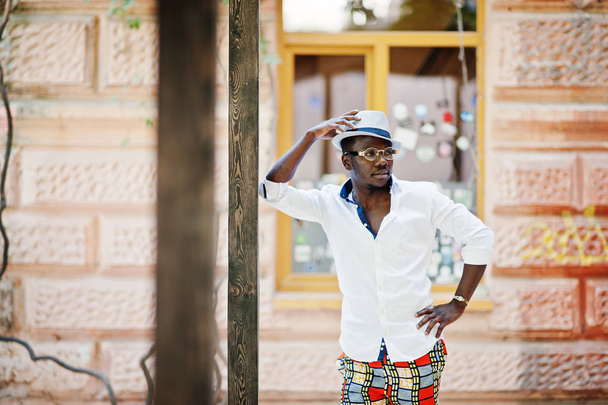 Stylish african american man in white shirt and colored pants wi - Photo, image