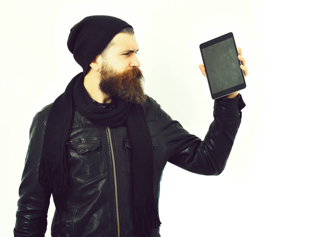 Bearded brutal caucasian hipster holding tablet - Фото, изображение