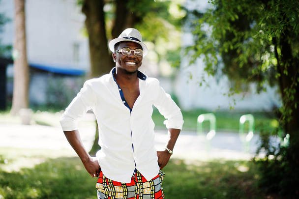 Stylish african american man in white shirt and colored pants wi - Fotografie, Obrázek