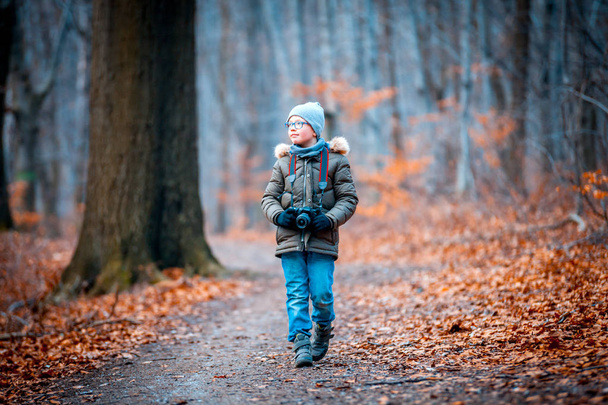 Boy with digital camera walking in the nature, hobby concept - Photo, Image