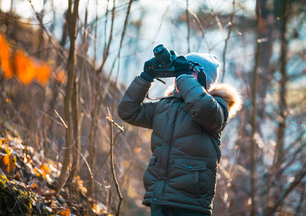 Boy using digital camera taking photo in the nature, hobby concept - Фото, зображення