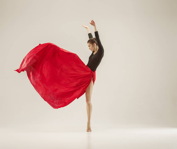 Modern ballet dancer dancing in full body on white studio background. - Zdjęcie, obraz