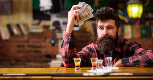Hipster holds money, counting cash to buy more alcohol. - Fotografie, Obrázek