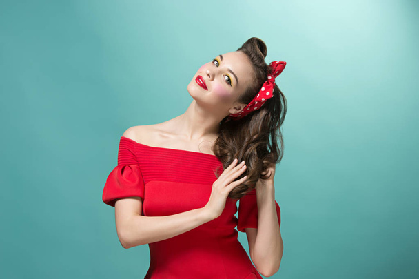 Beautiful young woman with pinup make-up and hairstyle. Studio shot on white background - Fotoğraf, Görsel
