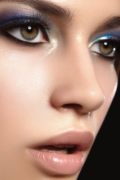 Closeup with of beautiful woman. Fashion makeup, clean shiny skin with highlighter. Makeup and cosmetic. Beauty style - 写真・画像