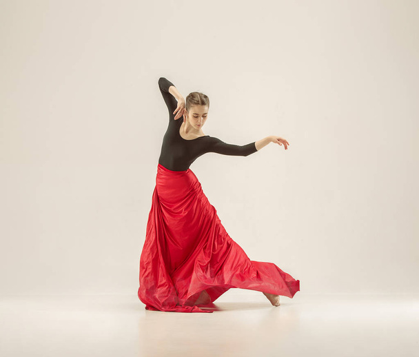 Modern ballet dancer dancing in full body on white studio background. - Photo, image