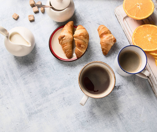 Top view of breakfast with cups of coffee and croissants - Фото, зображення