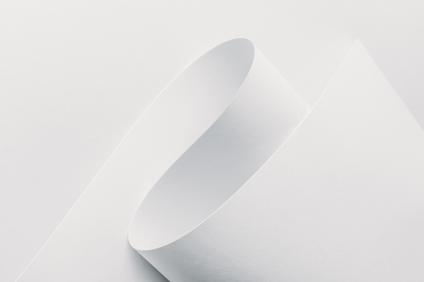 Close-up view of white rolled paper on white background - Photo, Image
