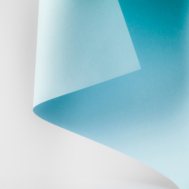 bright blue paper sheet on grey background   - Foto, afbeelding
