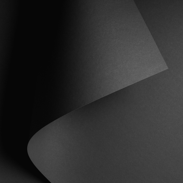 dark abstract background with black rolled paper sheet - Φωτογραφία, εικόνα