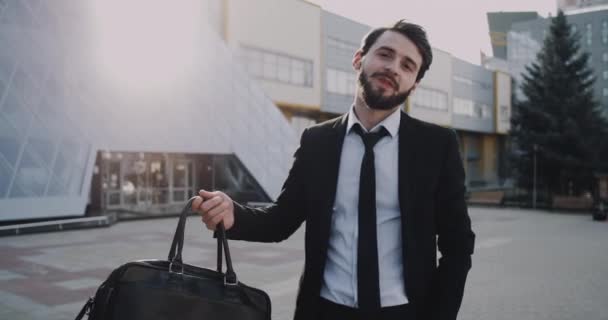 In the morning office worker coming to work happy smiling in front of the office building. - Materiał filmowy, wideo