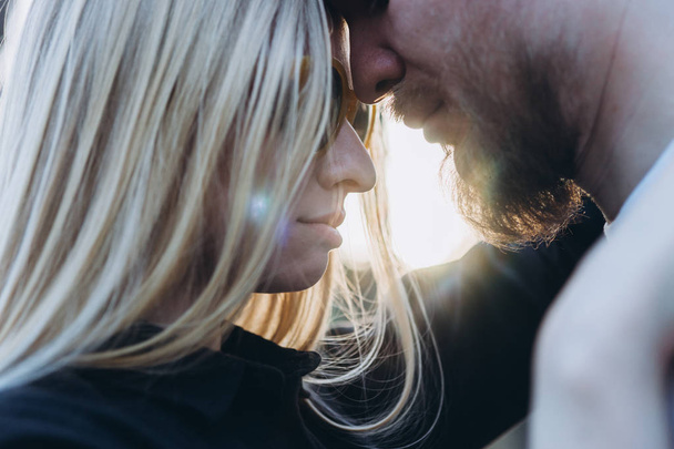 Young couple embracing in sunlight - Photo, Image