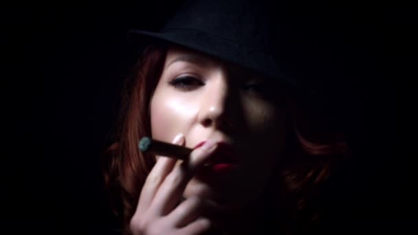 Girl smoking on black background - Footage, Video