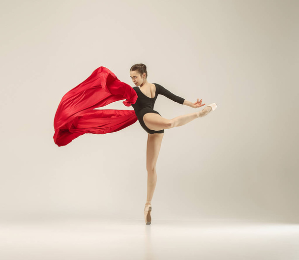 Modern ballet dancer dancing in full body on white studio background. - Photo, image