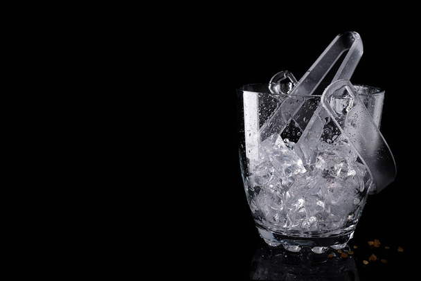 Glass ice bucket isolated on black with copy space - Photo, Image
