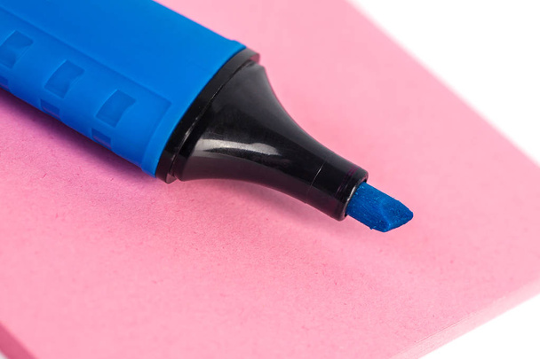 Blue marker and paper on a white background. - Photo, Image