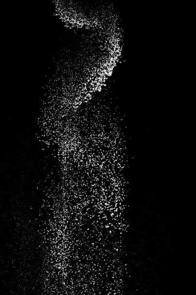 Белый порошок брызги изолированы на черном фоне. Просеивание муки на черном фоне. Взрывной порошок белый
 - Фото, изображение