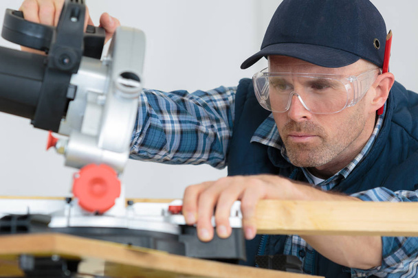 construction worker using slider compound mitre saw - Photo, image