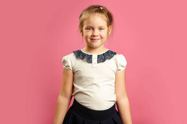 Frontal portrait of beautiful little girl in shape. - Photo, Image