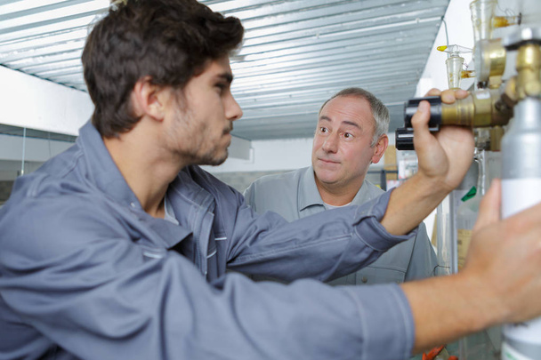 portrait of plumber with apprentice - Photo, Image