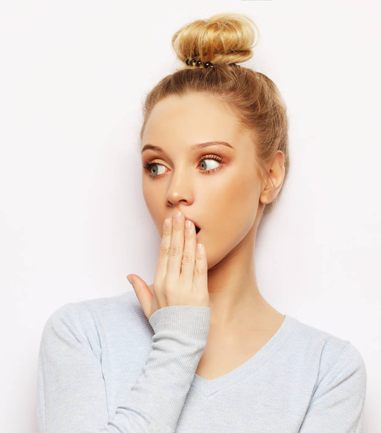 Indoor shot of stupefied shocked blonde woman keeps mouth widely opened, looks at camera, wears casual clothes, isolated over white background. Attractive female model indoor. - Photo, Image