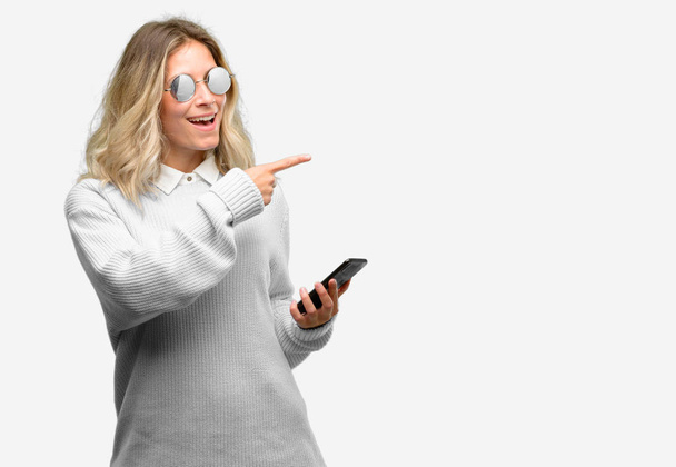 Fiatal gyönyörű nő használ smartphone mutató ujjával el oldalán - Fotó, kép