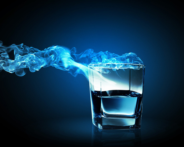 Image of glass of blue cocktail with fume going out - 写真・画像
