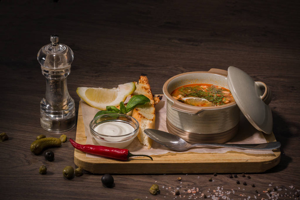 Soup on a wooden background with white bread and sauce - Photo, Image