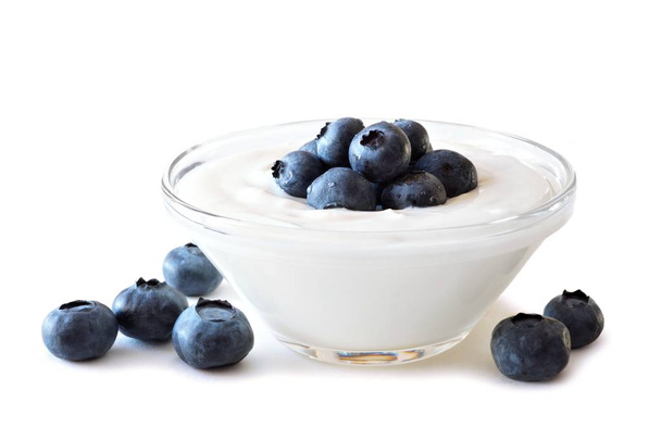 Clear bowl of yogurt with blueberries over a white background - Photo, Image