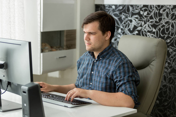 Portrait of young self employed man working at home office on computer - Foto, immagini