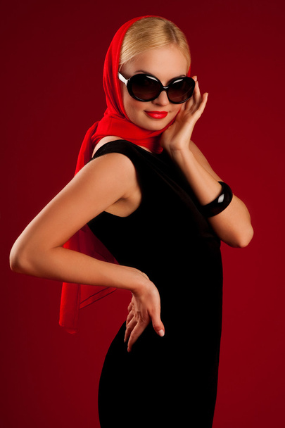 beautiful sexy blonde girl in black dress on red background - 写真・画像