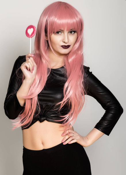 Beautiful young girl with pink hair, smile and brigth light with candy lolipop - Φωτογραφία, εικόνα