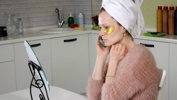 attractive woman spplying cosmetic facial patches at home - Foto, Bild