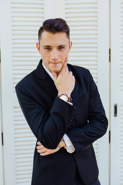Portrait of handsome man in black suit on the white background - Φωτογραφία, εικόνα