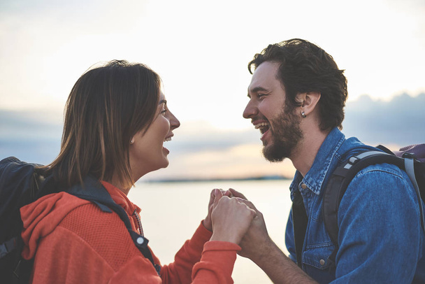 Excited young man and woman enjoying nature together - 写真・画像